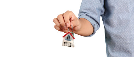 Real estate agent handing over a house keys in handの写真素材