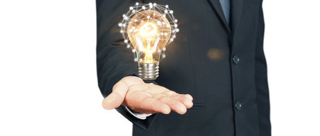 Humans hold light bulbs in hand innovative technology and creativityの写真素材