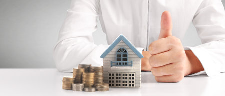House Residential Structure in hand ,business home idea, model house and coinの写真素材
