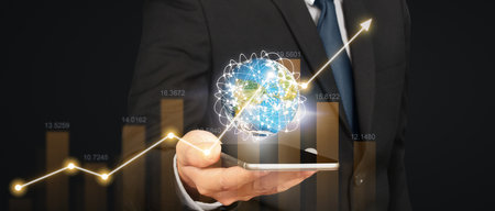 Hand holding smartphone device and touching screen. Stock exchange market concept.Trader looking onの写真素材
