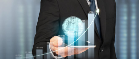 Hand holding smartphone device and touching screen. Stock exchange market concept.Trader looking onの写真素材