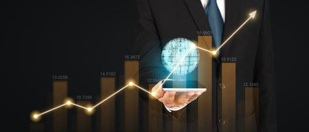 Hand holding smartphone device and touching screen. Stock exchange market concept.Trader looking onの写真素材