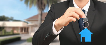 Real estate agent handing over a house keys in handの写真素材