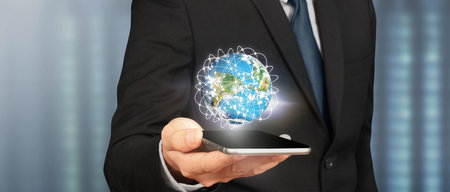 Hand holding smartphone device and touching screen. Stock exchange market concept.Trader looking onの写真素材