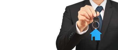 Real estate agent handing over a house keys in handの写真素材