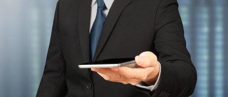 Hand holding smartphone device and touching screen. Stock exchange market concept.Trader looking onの写真素材