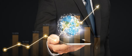 Hand holding smartphone device and touching screen. Stock exchange market concept.Trader looking onの写真素材
