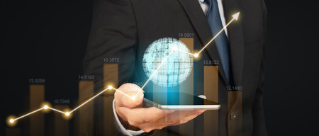 Hand holding smartphone device and touching screen. Stock exchange market concept.Trader looking onの写真素材