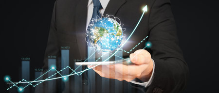 Hand holding smartphone device and touching screen. Stock exchange market concept.Trader looking onの写真素材