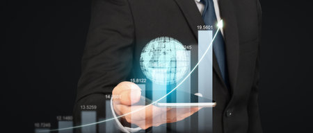 Hand holding smartphone device and touching screen. Stock exchange market concept.Trader looking onの写真素材