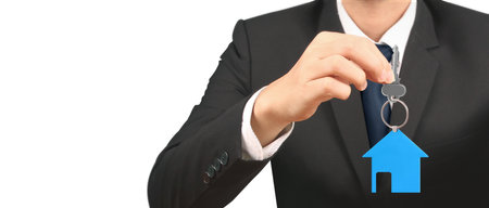 Real estate agent handing over a house keys in handの写真素材