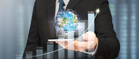 Hand holding smartphone device and touching screen. Stock exchange market concept.Trader looking onの写真素材