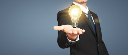 Humans hold light bulbs in hand innovative technology and creativityの写真素材