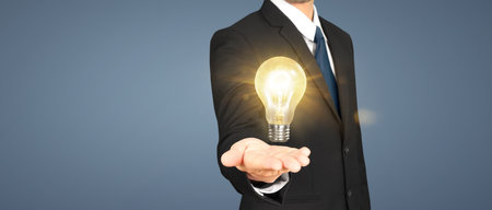 Man hold light bulbs in hand innovative technology and creativityの写真素材
