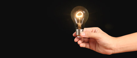 Humans hold light bulbs in hand innovative technology and creativityの写真素材