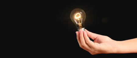 Humans hold light bulbs in hand innovative technology and creativityの写真素材