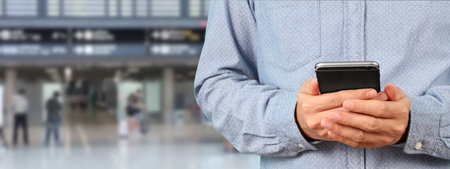 Man holding smartphone device and touching screenの写真素材