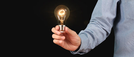 Man hold light bulbs in hand innovative technology and creativityの写真素材