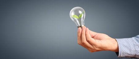 Humans hold light bulbs in hand innovative technology and creativityの写真素材