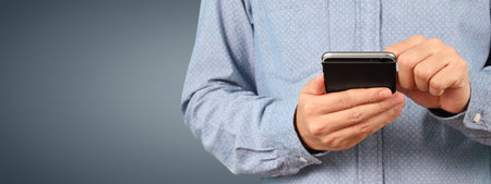 Man holding smartphone device and touching screen with five star rating feedback iconの写真素材
