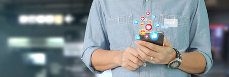 Man holding smartphone device and touching screen