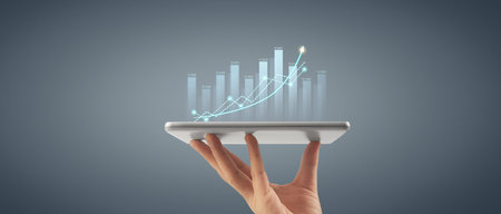 Plan graph growth and increase of chart positive indicators in his business,tablet in handの写真素材