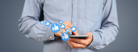 Man holding smartphone device and touching screenの写真素材