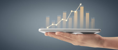 Plan graph growth and increase of chart positive indicators in his business,tablet in handの写真素材