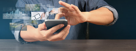Hand holding smartphone device and touching screen. Stock exchange market concepの写真素材
