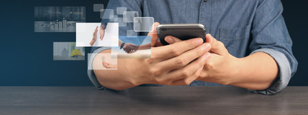 Hand holding smartphone device and touching screen. Stock exchange market concepの写真素材
