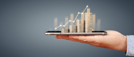 Hand holding smartphone device and touching screen. Stock exchange market concept.Trader lookingの写真素材