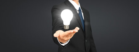 Humans hold light bulbs in hand innovative technology and creativityの写真素材