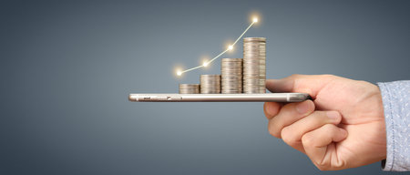 Hand holding smartphone device and touching screen. Stock exchange market concept.Trader lookingの写真素材