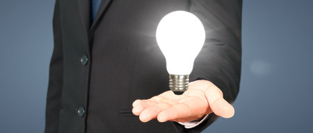 Humans hold light bulbs in hand innovative technology and creativityの写真素材