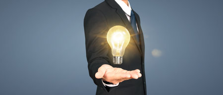Humans hold light bulbs in hand innovative technology and creativityの写真素材