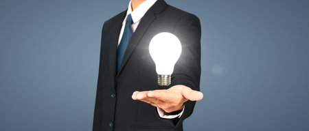 Humans hold light bulbs in hand innovative technology and creativityの写真素材