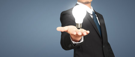 Humans hold light bulbs in hand innovative technology and creativityの写真素材