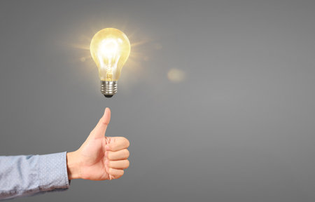 Humans hold light bulbs in hand innovative technology and creativityの写真素材