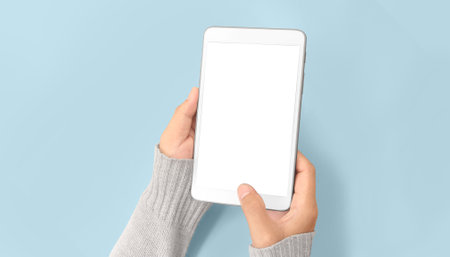Hands holding a tablet touch computer gadgetの写真素材