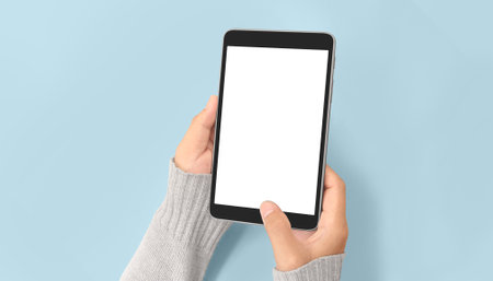 Hands holding a tablet touch computer gadgetの写真素材