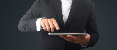 Hands holding a tablet touch computer gadgetの写真素材