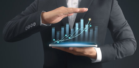 Businessman plan graph growth and increase of chart positive indicators in his business,tablet in handの写真素材