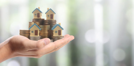 Hands and stock coins and model house ,money savingの写真素材