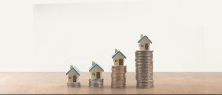 Mortgage concept by money house from model house on coinsの写真素材