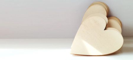 Creative heart-shaped wood crafting project home workshop diy art bright environment close-up view love conceptの写真素材