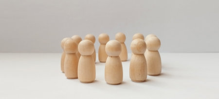 Group discussion among wooden figurines minimalist setting photography neutral background creative conceptの写真素材
