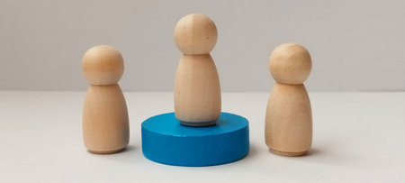 Group interaction with wooden figures minimalist studio conceptual art neutral background aesthetic perspectiveの写真素材