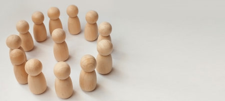 Group discussion among wooden figures minimalist setup conceptual art studio environment close-up viewの写真素材