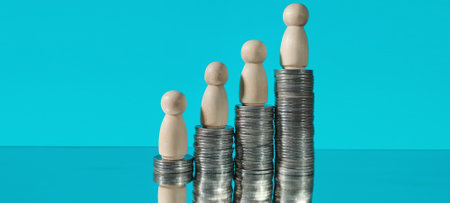 Investment growth analyzing financial trends with coin stacks and figures in a minimalist settingの写真素材