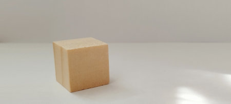 Dynamic rotation of a simple cube on a minimalist surface 3d visualization clean environment artistic perspectiveの写真素材